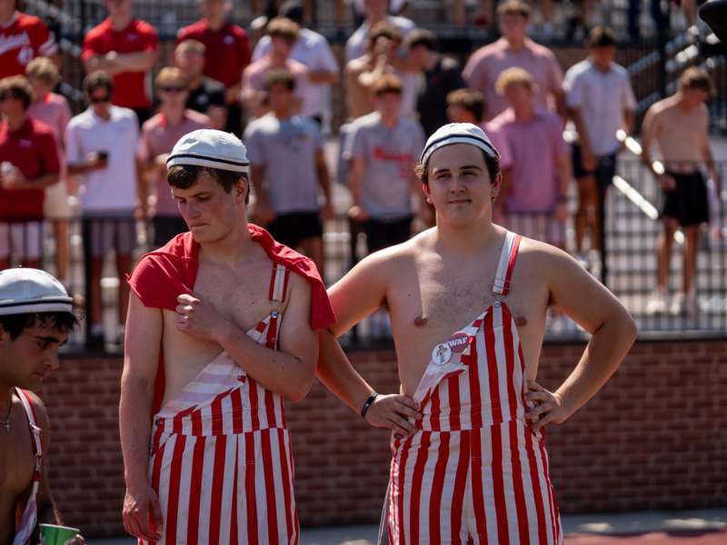two men wearing striped overalls