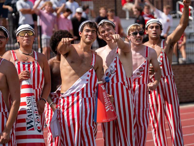 a group of men wearing striped overalls