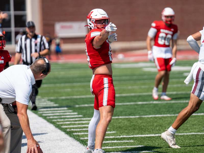 a football player pointing at the ball