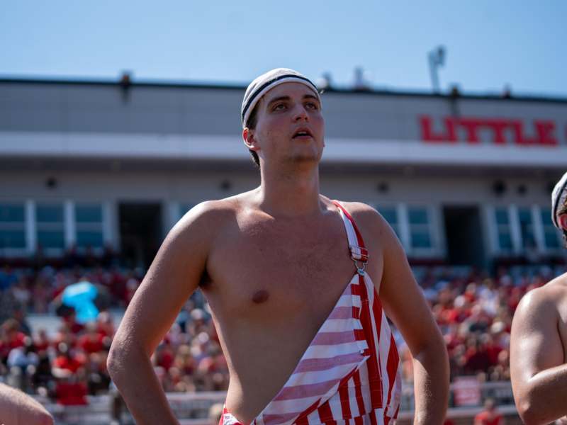 a man in a red and white striped overalls