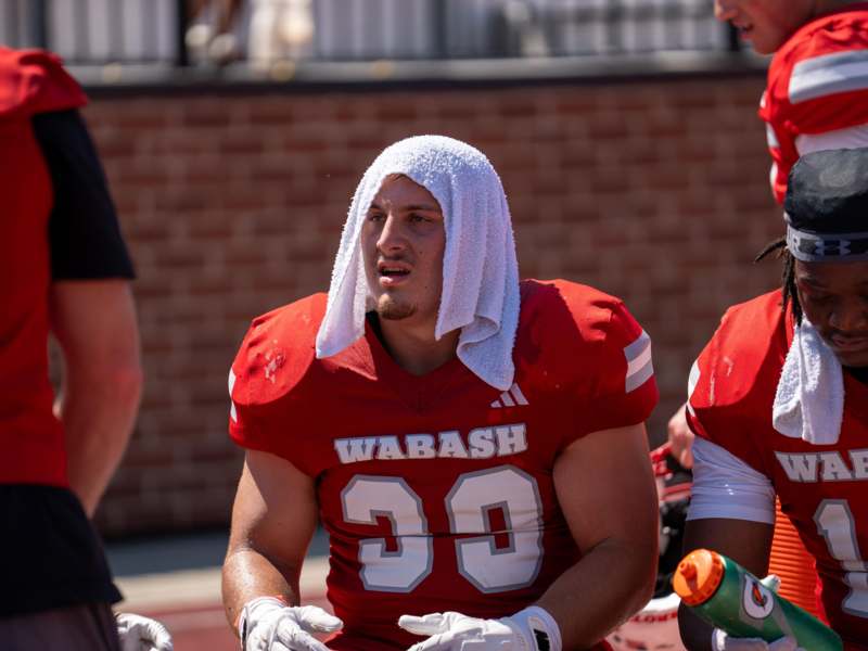 a football player with a towel on his head