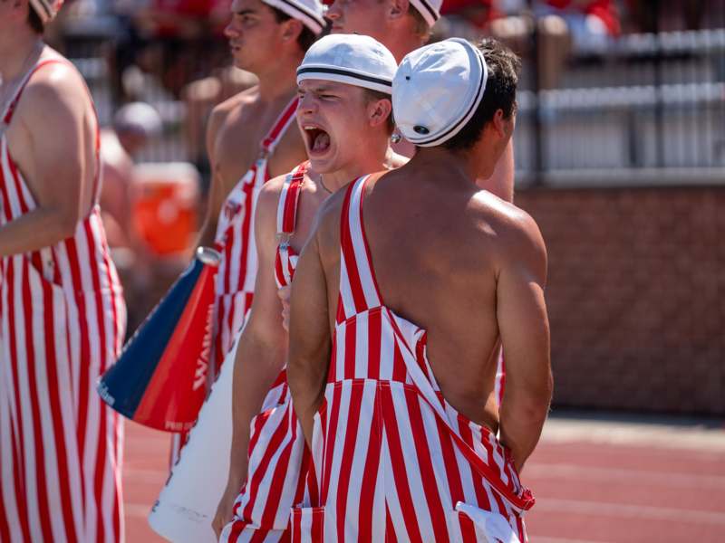 a group of men wearing striped overalls