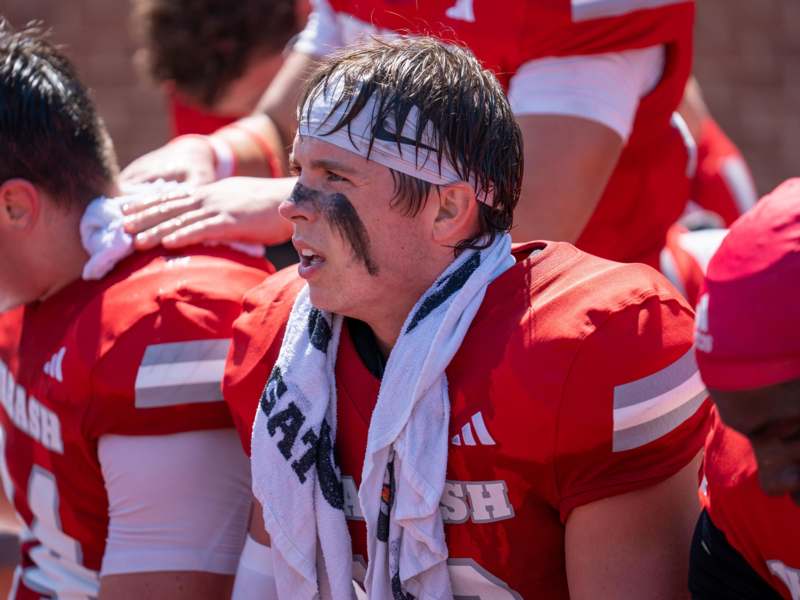 a football player with a white towel around his neck