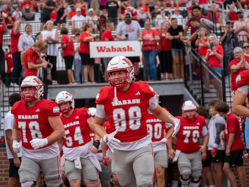 a group of football players in red and white uniforms