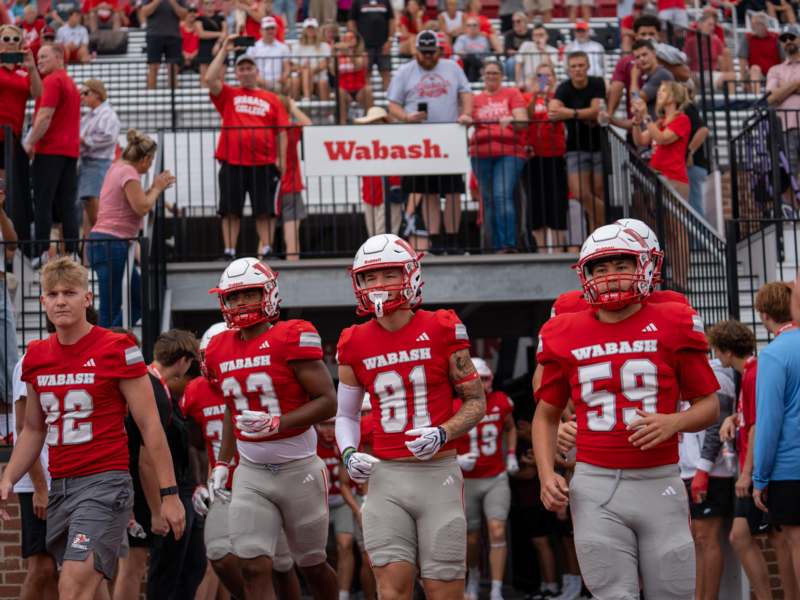 a group of football players in red and white uniforms