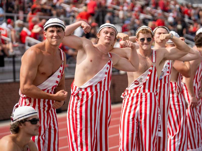 a group of men flexing their muscles