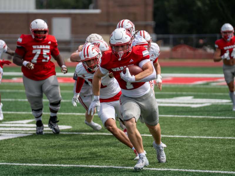 a group of football players running on a field