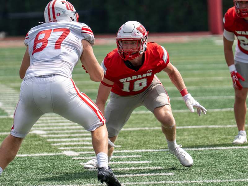 a football player in a red uniform playing football