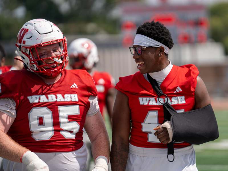 two football players wearing red and white jerseys