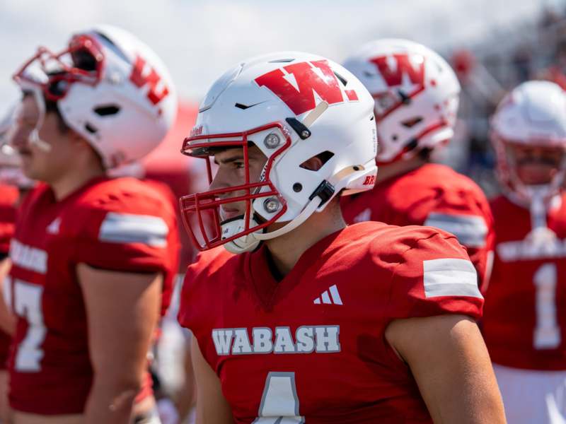 a group of football players wearing red and white football uniforms