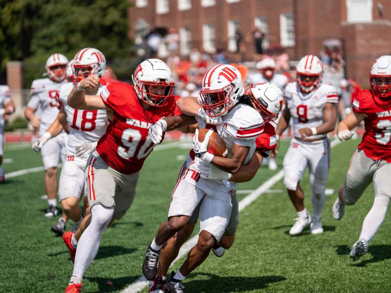a group of football players running on a field