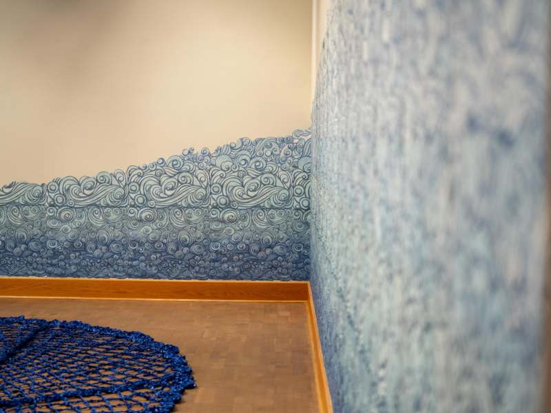 a blue rug on a floor in a room