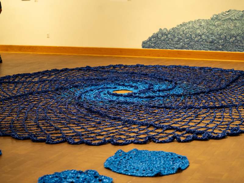 a blue rug on a wood floor
