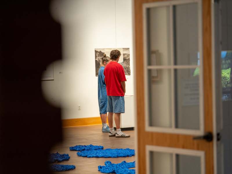 a group of people looking at a painting