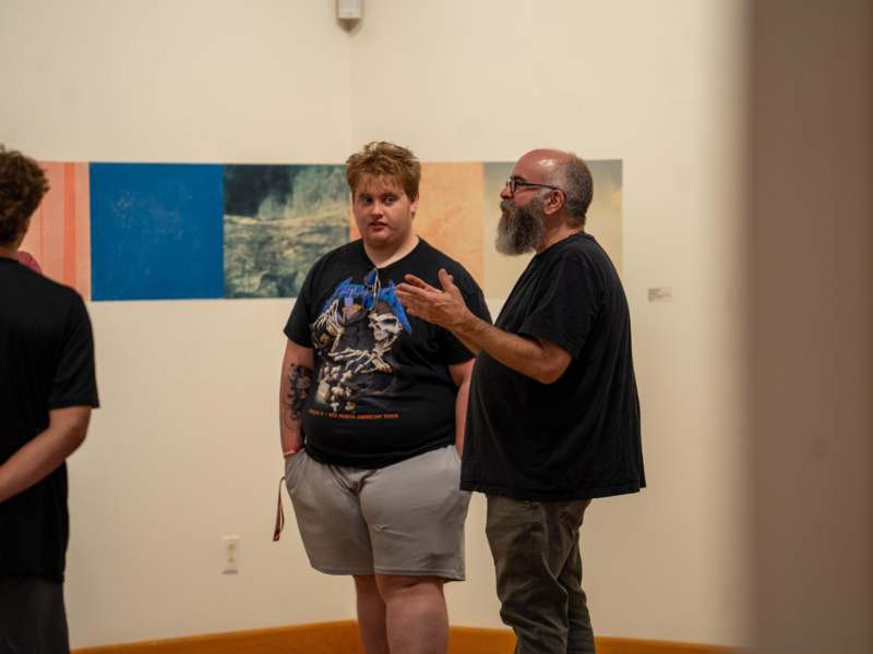 a man standing next to another man