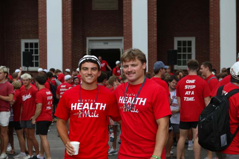 two men wearing red shirts