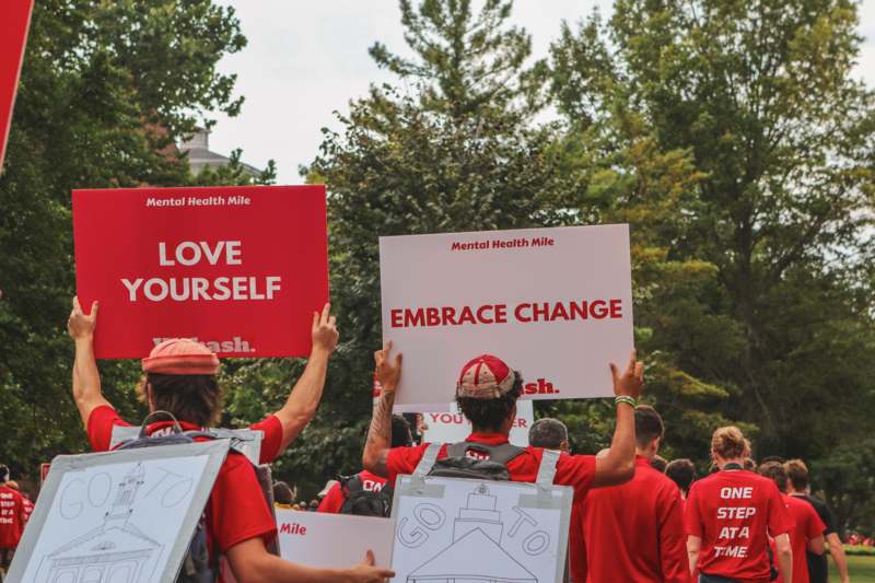 a group of people holding signs