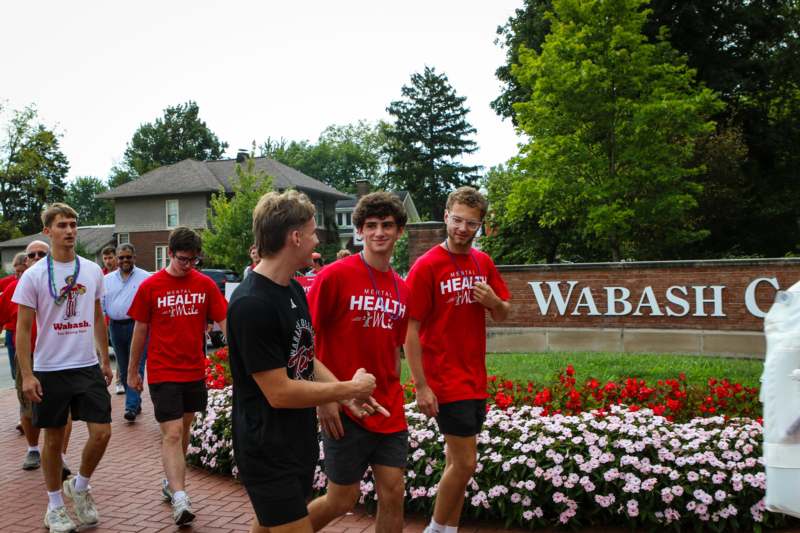 a group of people walking on a brick path