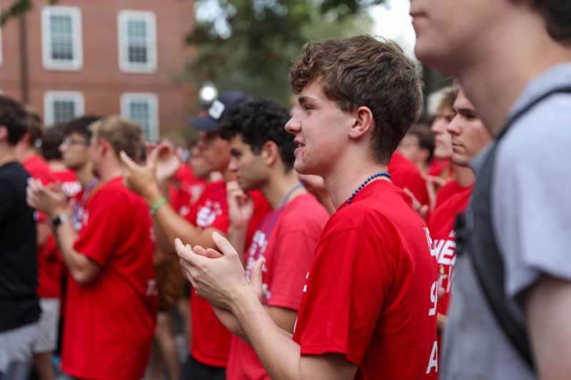 a group of people in red shirts