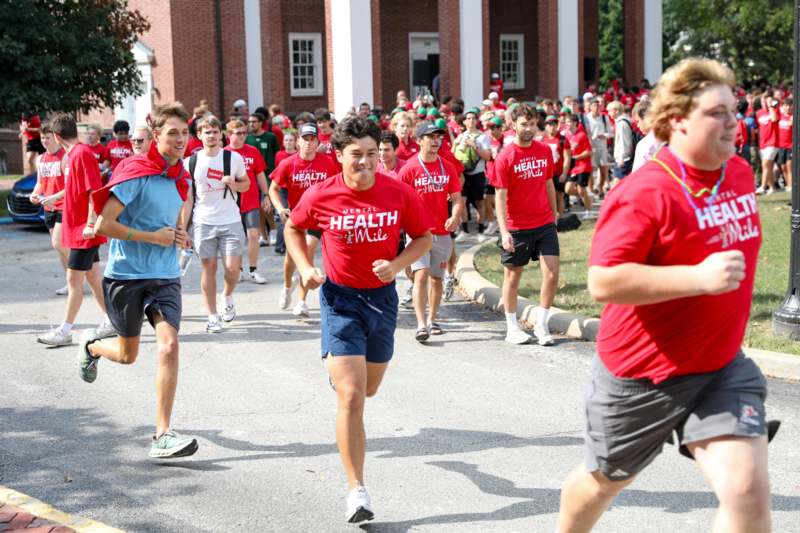 a group of people running in a street