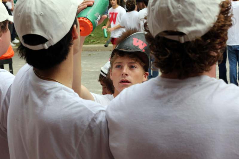 a group of people wearing white shirts