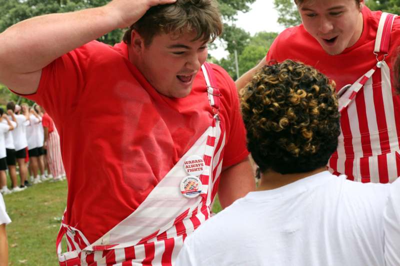 a group of people in red and white striped aprons