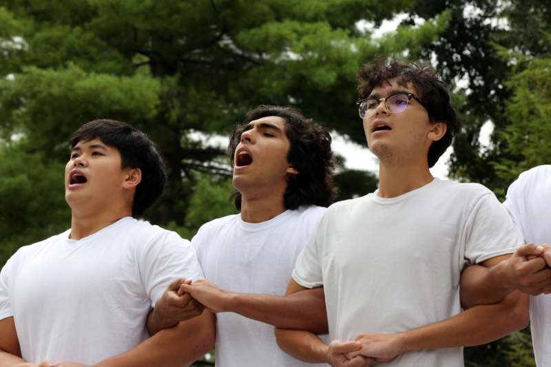 a group of men in white shirts