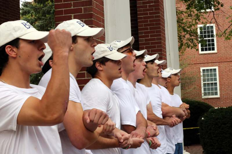 a group of men wearing white shirts and white hats