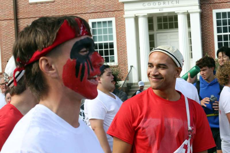 a man with a painted face and a red headband