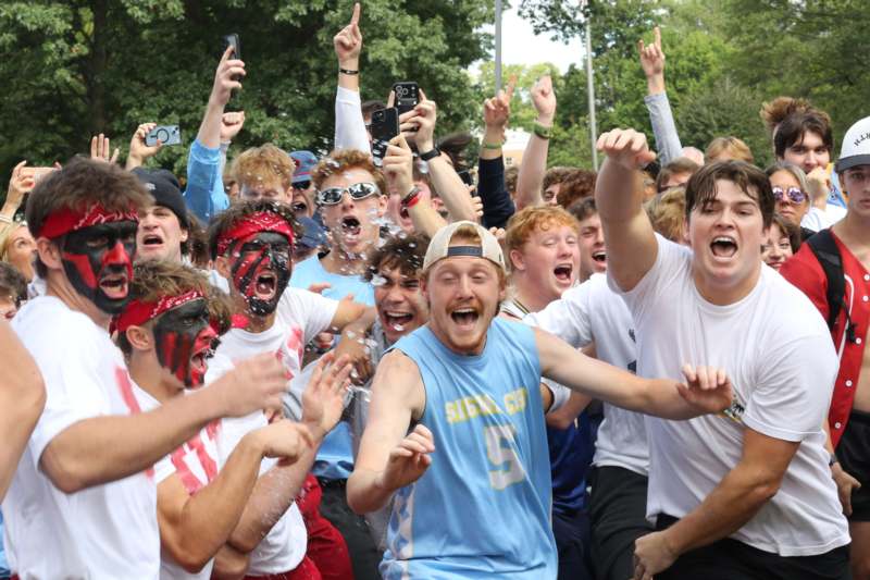 a group of people with their hands up