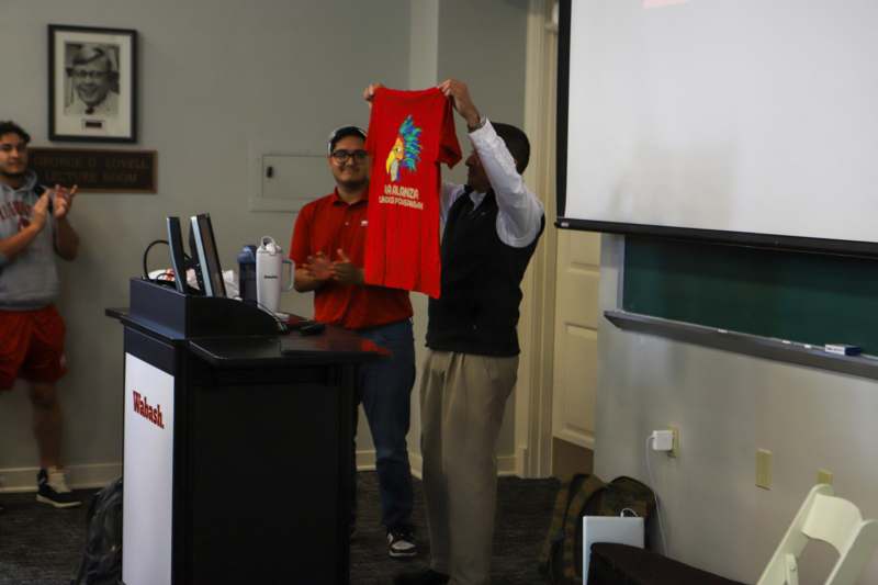 a man holding a red shirt
