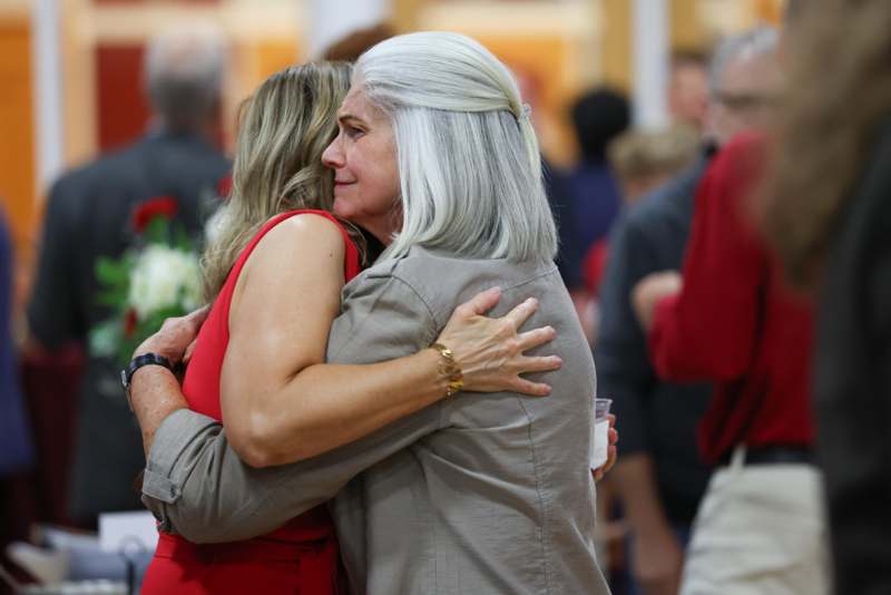 a woman hugging another woman