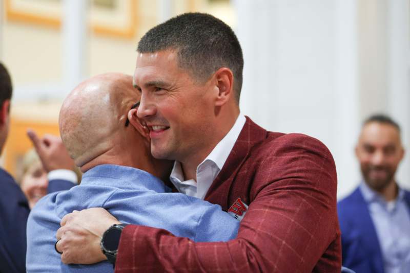 a man hugging another man
