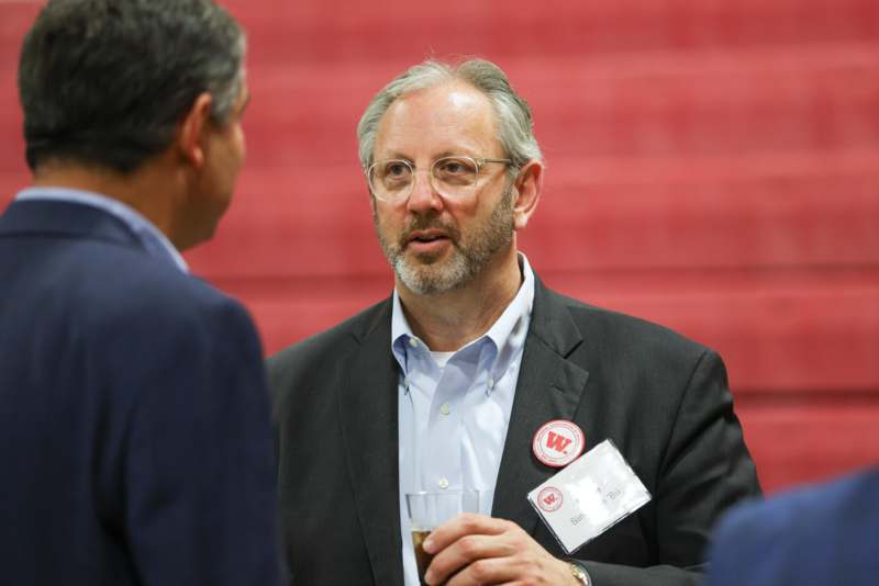a man in a suit talking to another man