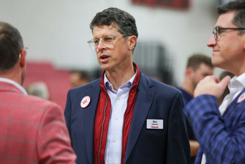 a man in a suit with a badge