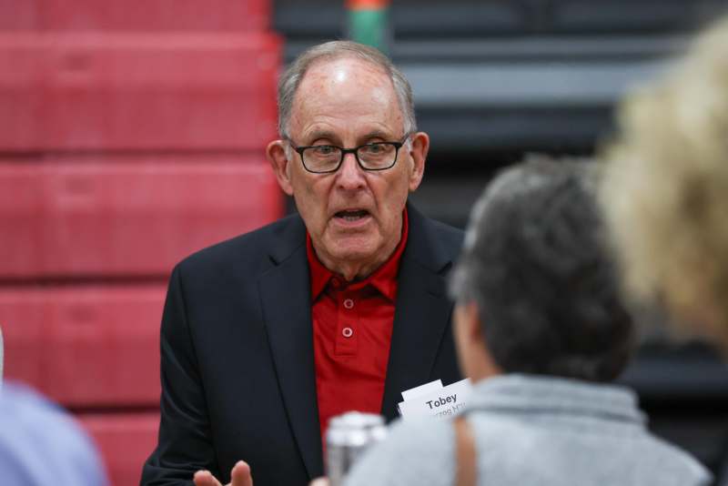 a man in a suit talking to a woman