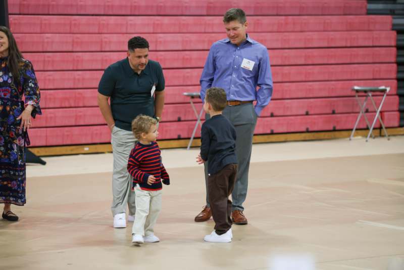 a group of men standing in a gym