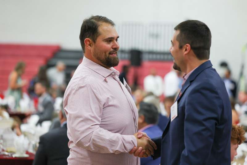a man shaking hands with another man