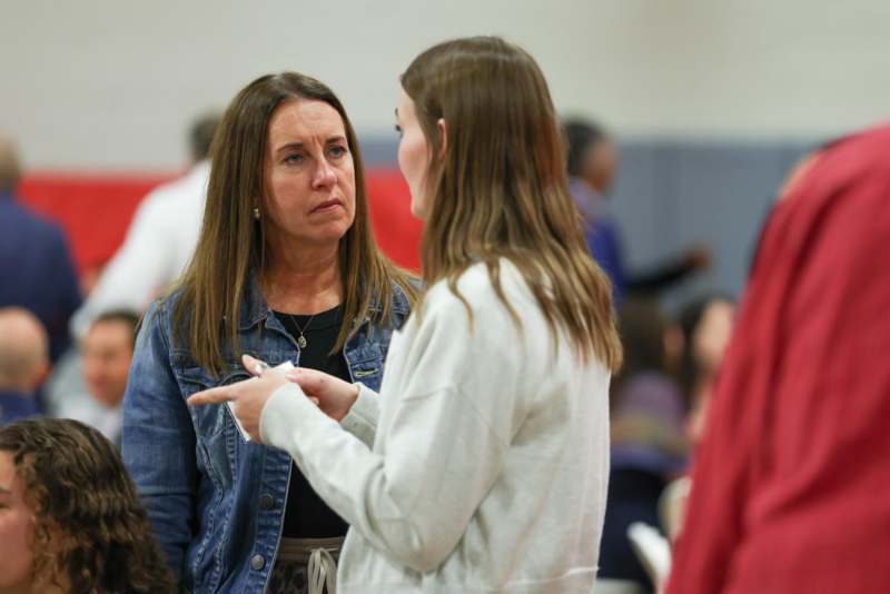 a woman talking to another woman