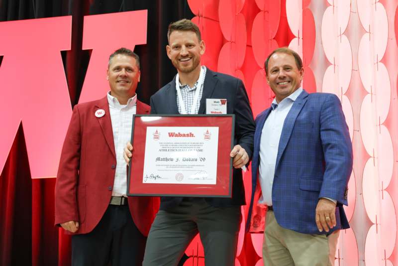 a group of men holding a certificate