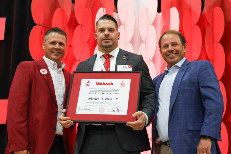 a group of men holding a certificate
