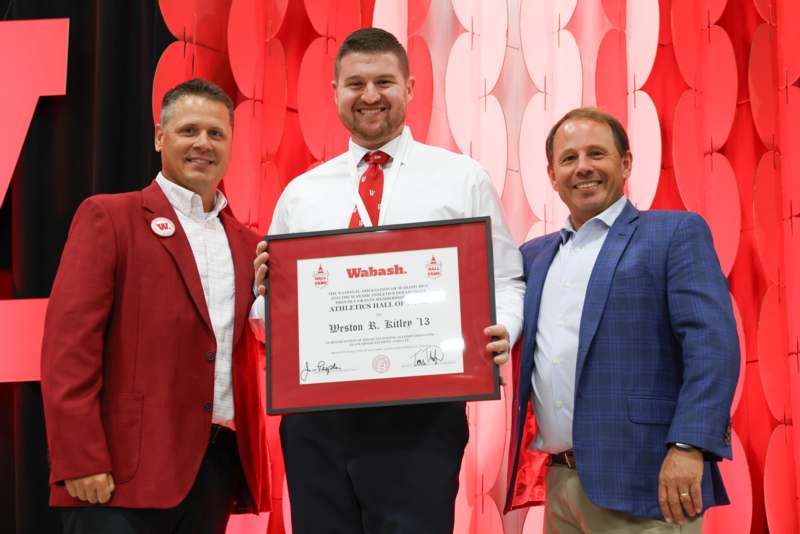 a group of men holding a certificate