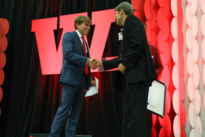 a man shaking hands with another man