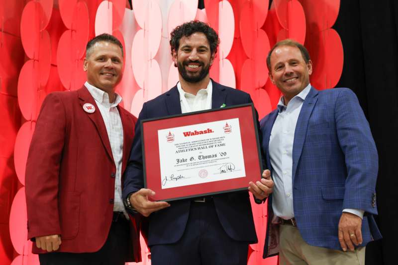 a group of men holding a certificate