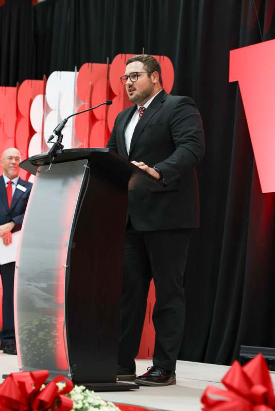 a man standing at a podium with a microphone