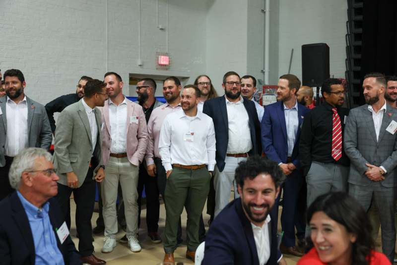 a group of men standing in a room