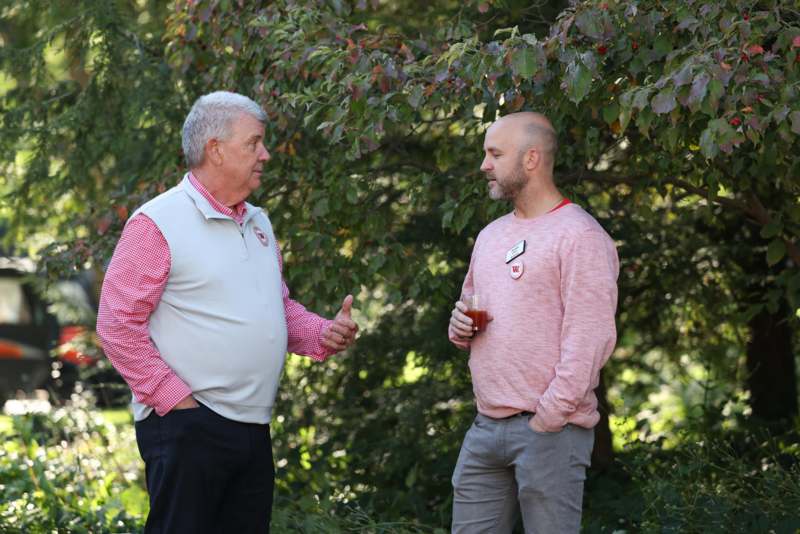 two men standing outside talking
