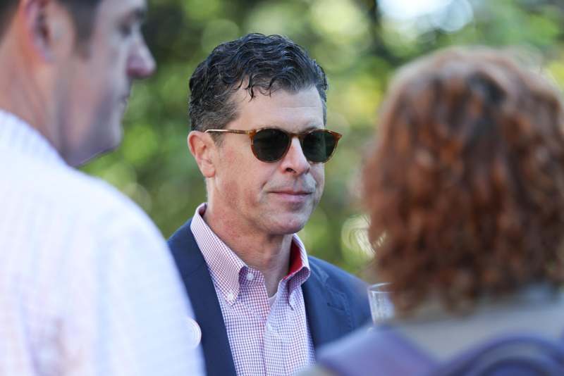 a man wearing sunglasses and a red checkered shirt