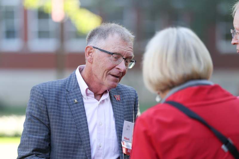 a man in a suit talking to a woman