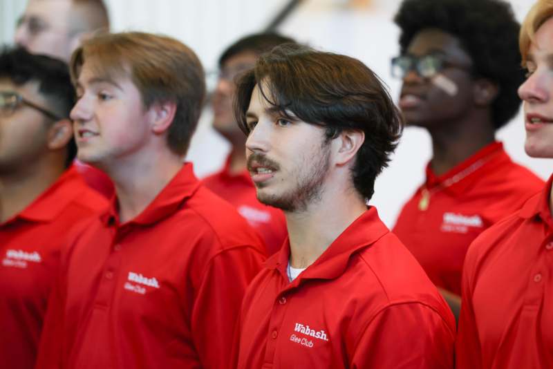 a group of men in red shirts
